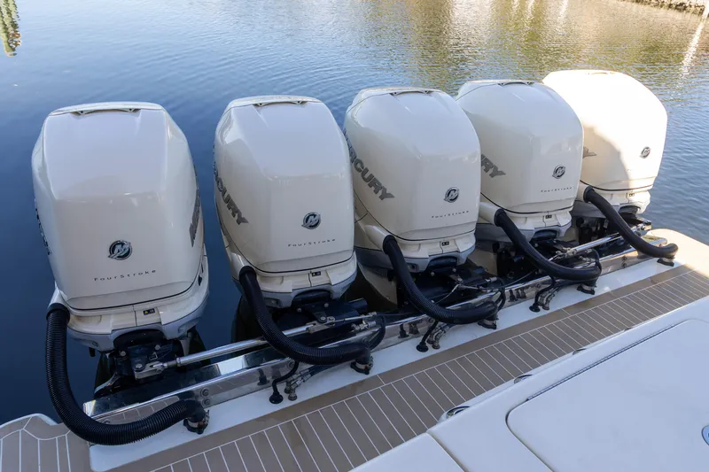  Yacht Photos Pics Five powerful outboard engines on a 2020 Scout 530LXF boat, docked on calm water.