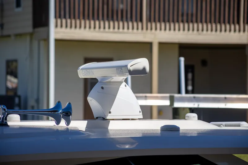  Yacht Photos Pics Radar equipment on 2020 Scout 530LXF boat, docked near a building.