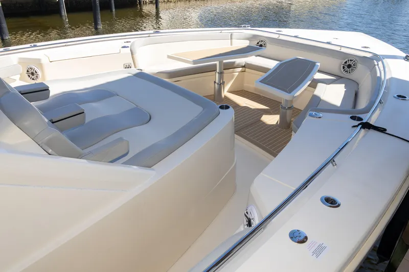  Yacht Photos Pics 2020 Scout 530LXF boat interior with seating and table, docked by the water.