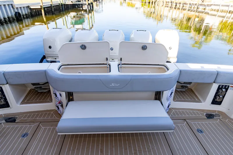  Yacht Photos Pics 2020 Scout 530LXF boat with open storage compartments and seating at the stern.