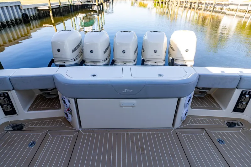  Yacht Photos Pics 2020 Scout 530LXF boat with five powerful outboard engines docked by the water.