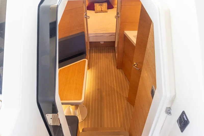  Yacht Photos Pics Interior view of 2020 Scout 530LXF boat cabin with seating and bed.