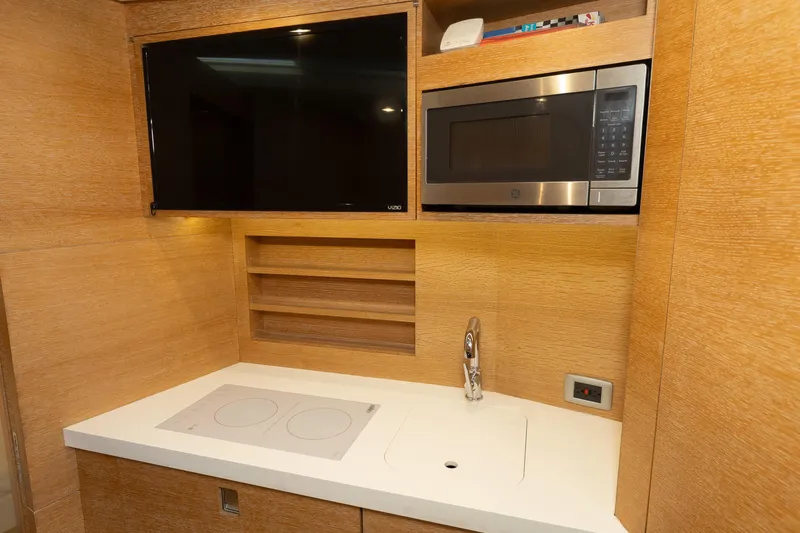  Yacht Photos Pics Modern kitchen area in 2020 Scout 530LXF yacht with TV and microwave.