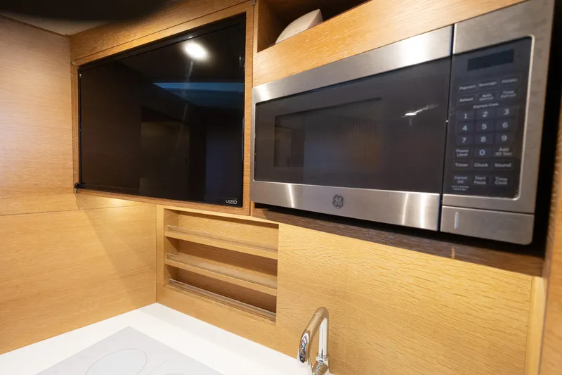  Yacht Photos Pics Modern kitchen area in 2020 Scout 530LXF with microwave and TV.
