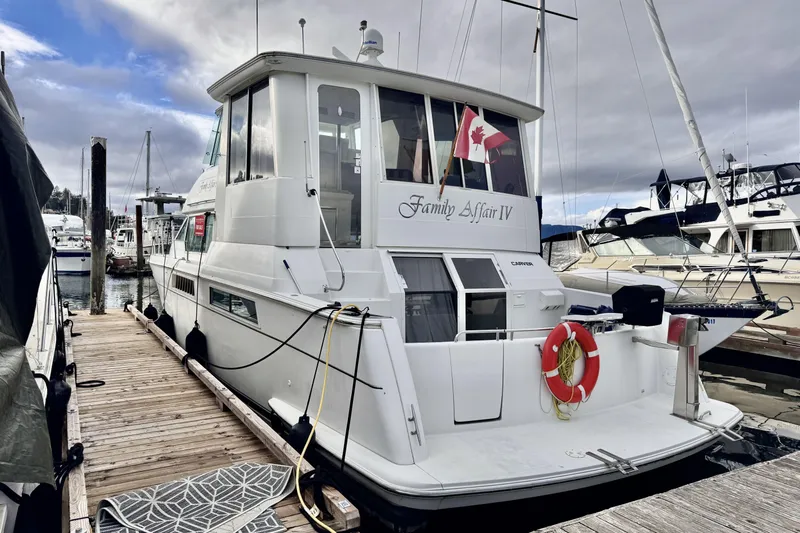 Family Affair IV Yacht Photos Pics 1997 Carver 500 Cockpit Motor Yacht docked, featuring Canadian flag and lifebuoy.