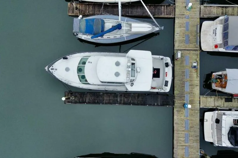 Family Affair IV Yacht Photos Pics Aerial view of a 1997 Carver 500 Cockpit Motor Yacht docked at a marina.