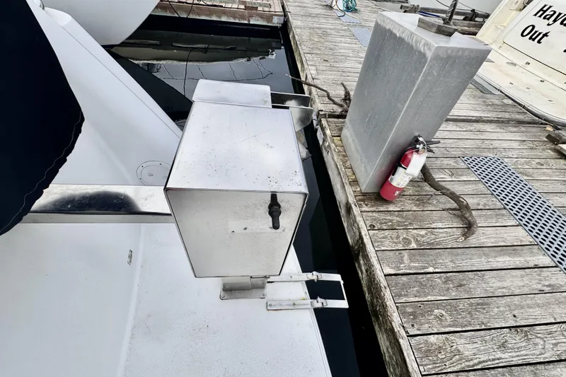 Family Affair IV Yacht Photos Pics Docked 1997 Carver 500 Cockpit Motor Yacht with fire extinguisher on wooden pier.