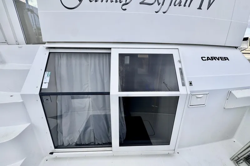 Family Affair IV Yacht Photos Pics 1997 Carver 500 Cockpit Motor Yacht with sliding glass door and curtains.