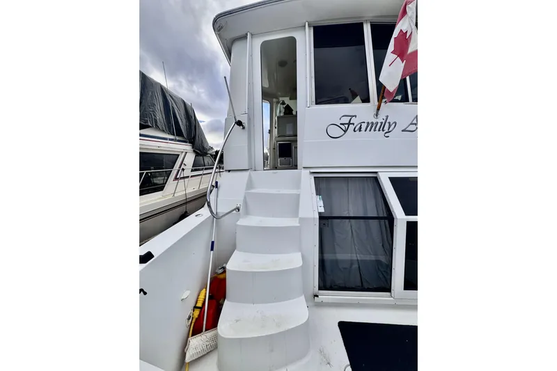 Family Affair IV Yacht Photos Pics 1997 Carver 500 Cockpit Motor Yacht with stairs and Canadian flag.