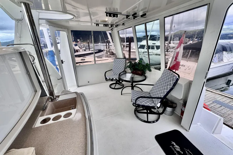 Family Affair IV Yacht Photos Pics 1997 Carver 500 Cockpit Motor Yacht interior with seating, table, and marina view.