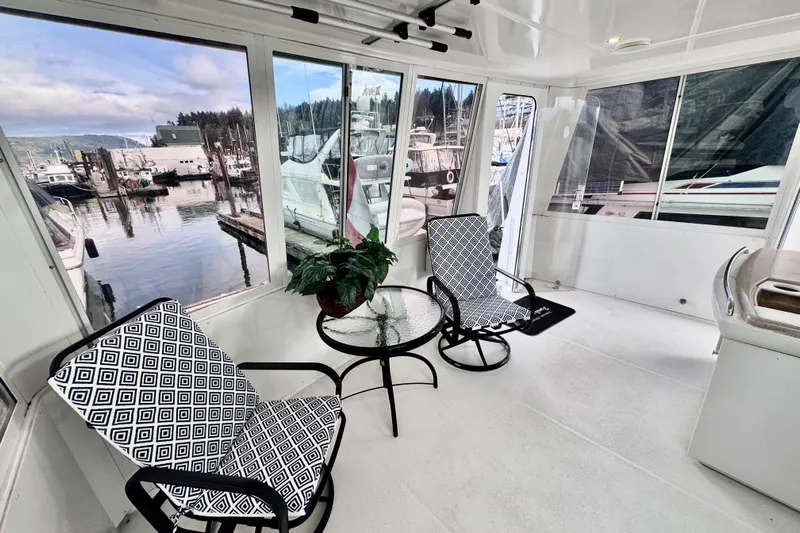 Family Affair IV Yacht Photos Pics 1997 Carver 500 Cockpit Motor Yacht interior with chairs, table, and marina view.