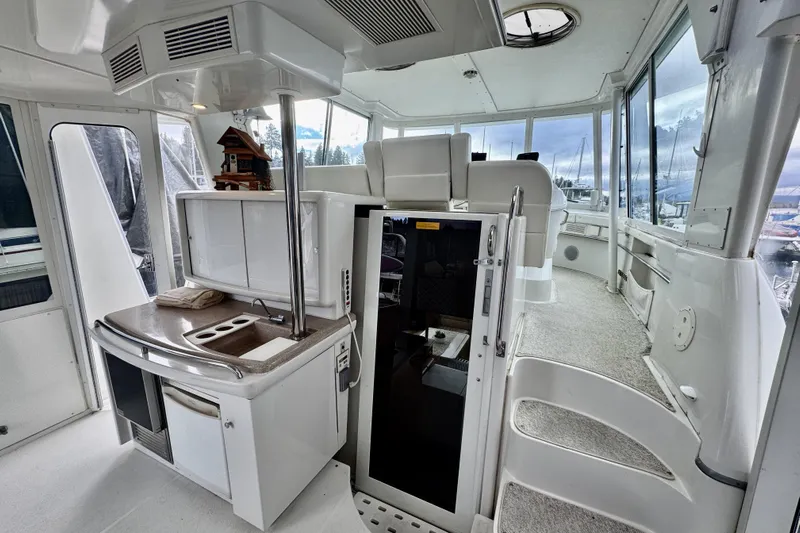 Family Affair IV Yacht Photos Pics Interior of 1997 Carver 500 Cockpit Motor Yacht with modern amenities and panoramic windows.