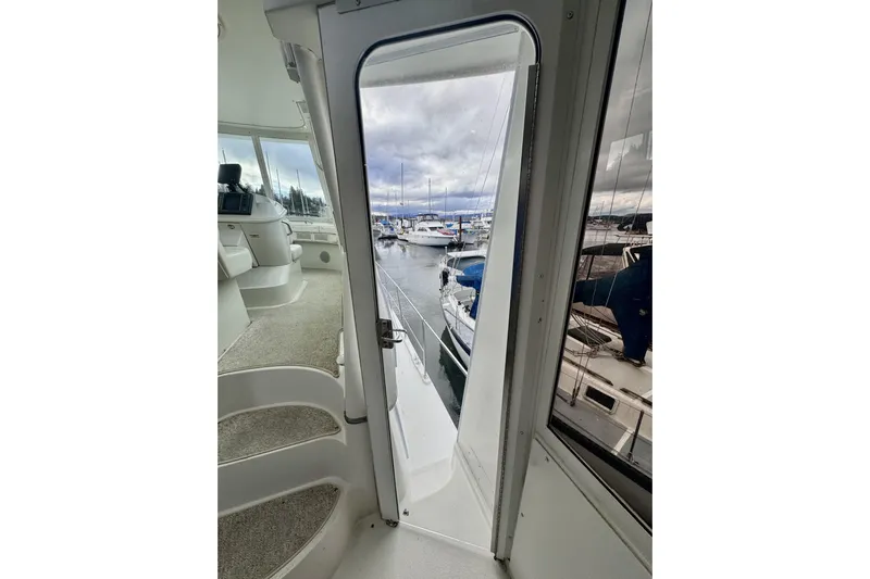 Family Affair IV Yacht Photos Pics 1997 Carver 500 Cockpit Motor Yacht interior view with marina in background.