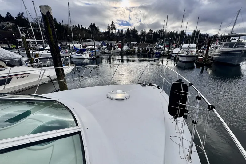 Family Affair IV Yacht Photos Pics 1997 Carver 500 Cockpit Motor Yacht docked in a marina under cloudy skies.