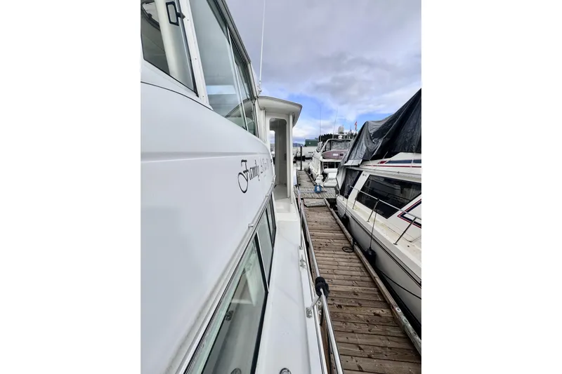 Family Affair IV Yacht Photos Pics 1997 Carver 500 Cockpit Motor Yacht docked alongside other boats.