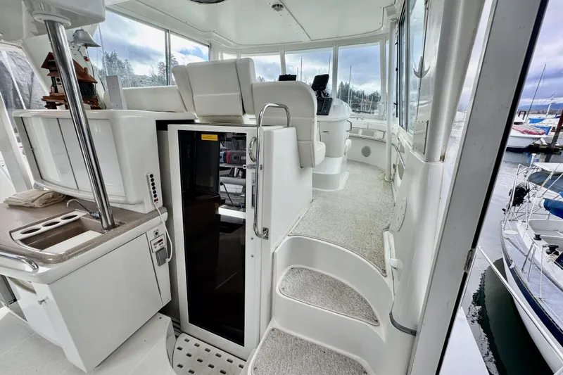 Family Affair IV Yacht Photos Pics Interior view of 1997 Carver 500 Cockpit Motor Yacht, featuring helm and seating area.