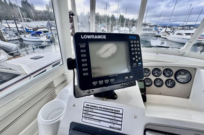 Family Affair IV Yacht Photos Pics Cockpit view of 1997 Carver 500 Yacht with Lowrance X70A display and marina background.