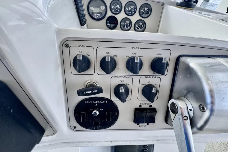 Family Affair IV Yacht Photos Pics Control panel of a 1997 Carver 500 Cockpit Motor Yacht with various switches and gauges.