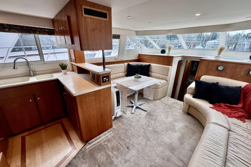 Family Affair IV Yacht Photos Pics Luxurious interior of 1997 Carver 500 Cockpit Motor Yacht with plush seating and modern kitchen.