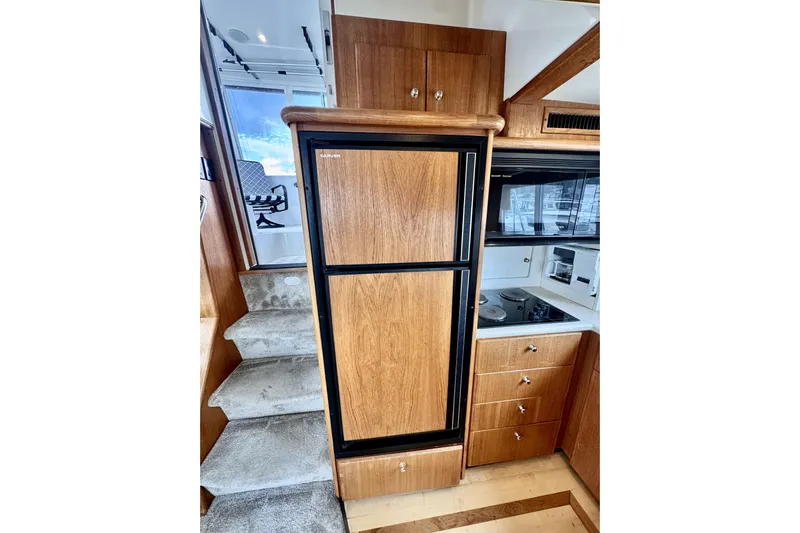 Family Affair IV Yacht Photos Pics Interior of 1997 Carver 500 Cockpit Motor Yacht with kitchen and stairs.