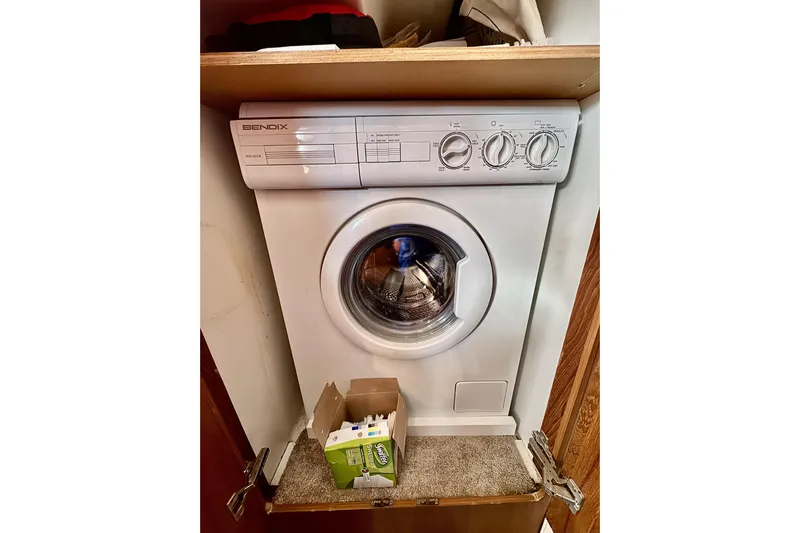 Family Affair IV Yacht Photos Pics Washing machine inside a 1997 Carver 500 Cockpit Motor Yacht cabinet.