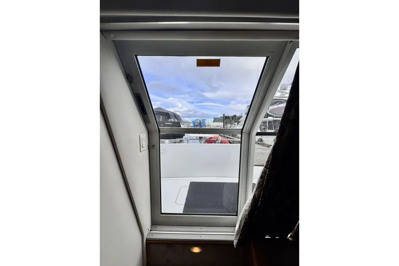 Family Affair IV Yacht Photos Pics View through window of 1997 Carver 500 Cockpit Motor Yacht, showing marina and sky.