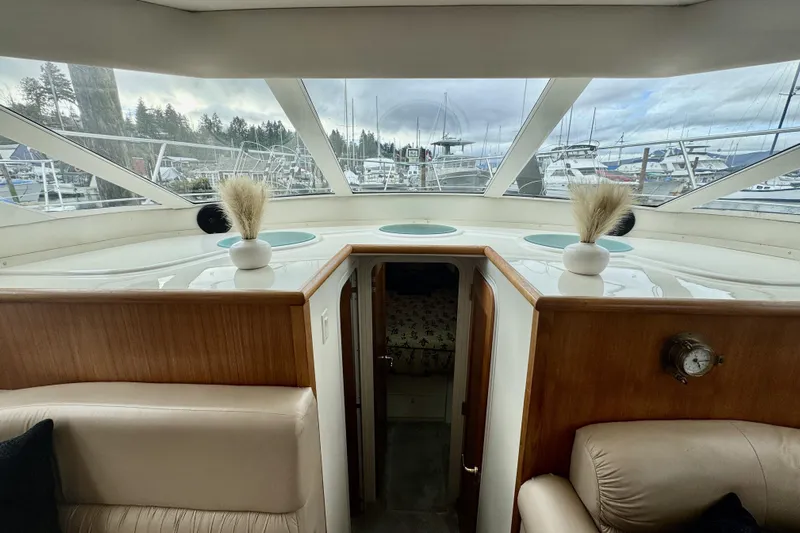 Family Affair IV Yacht Photos Pics Interior view of 1997 Carver 500 Cockpit Motor Yacht with scenic marina backdrop.