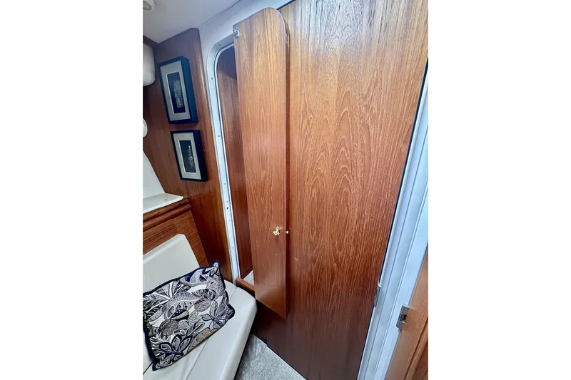 Family Affair IV Yacht Photos Pics Interior of 1997 Carver 500 Cockpit Motor Yacht with wooden door and framed art.