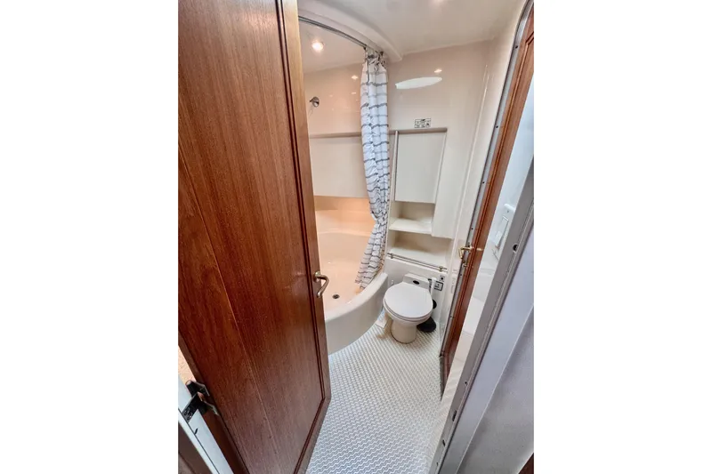 Family Affair IV Yacht Photos Pics Bathroom interior of 1997 Carver 500 Cockpit Motor Yacht with shower and toilet.