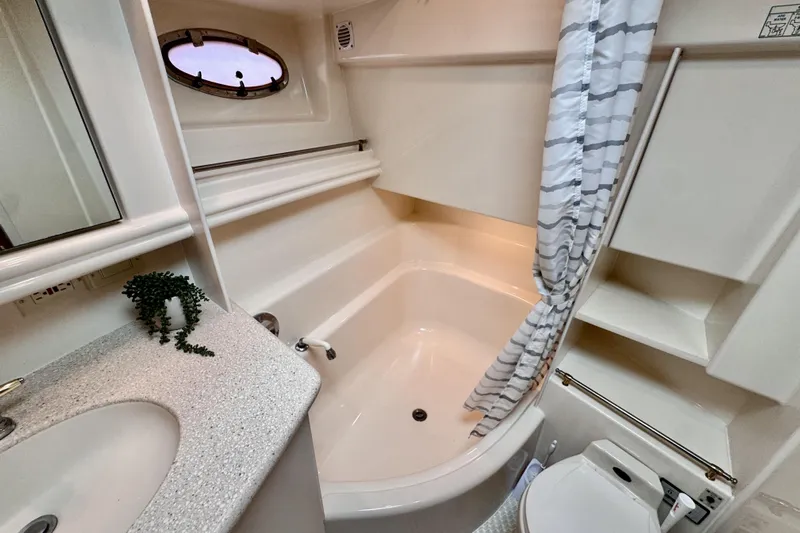 Family Affair IV Yacht Photos Pics Bathroom interior of 1997 Carver 500 Cockpit Motor Yacht with shower and sink.