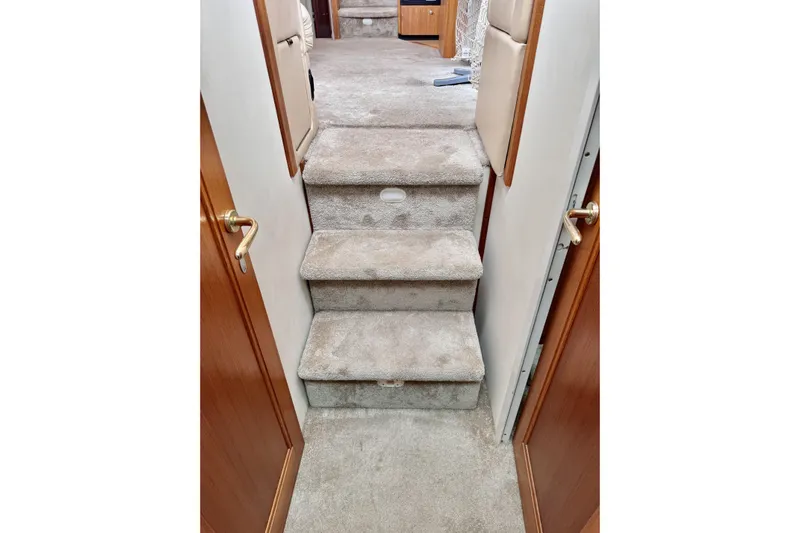 Family Affair IV Yacht Photos Pics Carpeted stairs inside 1997 Carver 500 Cockpit Motor Yacht, featuring wooden doors.