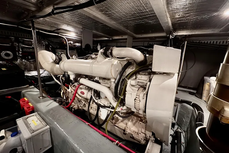 Family Affair IV Yacht Photos Pics Engine room of a 1997 Carver 500 Cockpit Motor Yacht, showcasing detailed machinery.