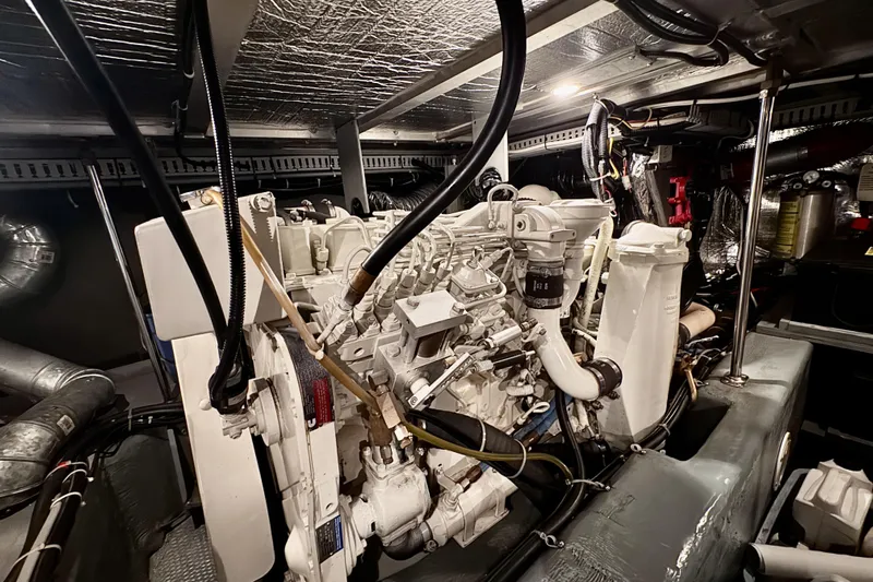 Family Affair IV Yacht Photos Pics Engine room of a 1997 Carver 500 Cockpit Motor Yacht, showcasing detailed machinery.