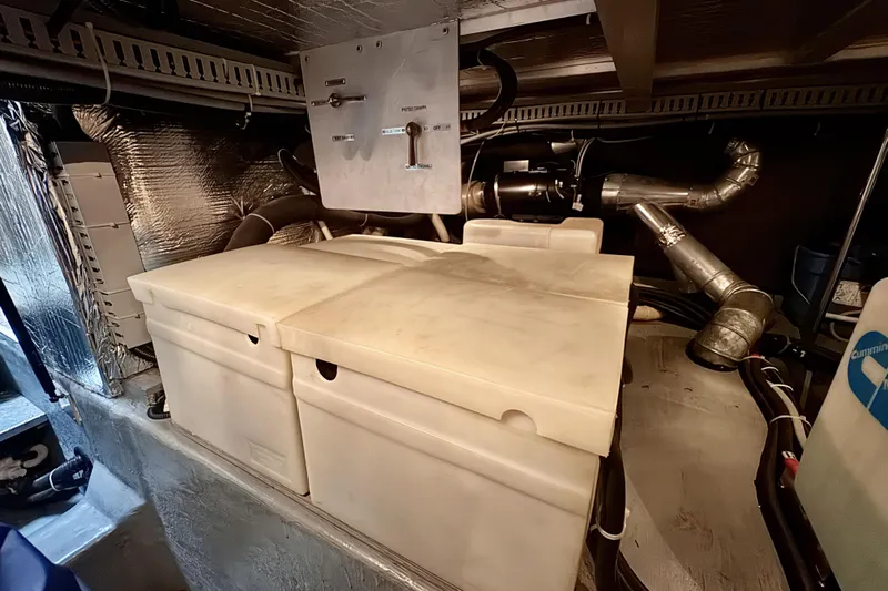 Family Affair IV Yacht Photos Pics Engine room of 1997 Carver 500 Cockpit Motor Yacht with storage compartments and piping.