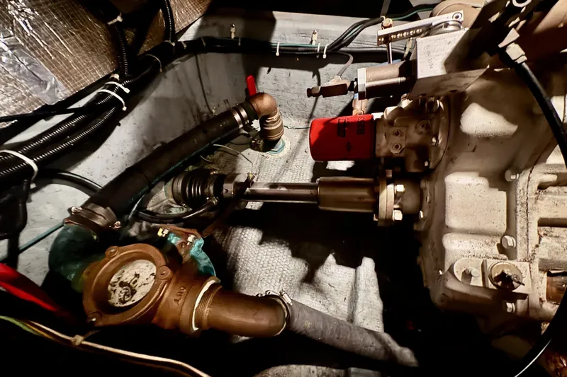 Family Affair IV Yacht Photos Pics Engine compartment of a 1997 Carver 500 Cockpit Motor Yacht, showing mechanical components and hoses.