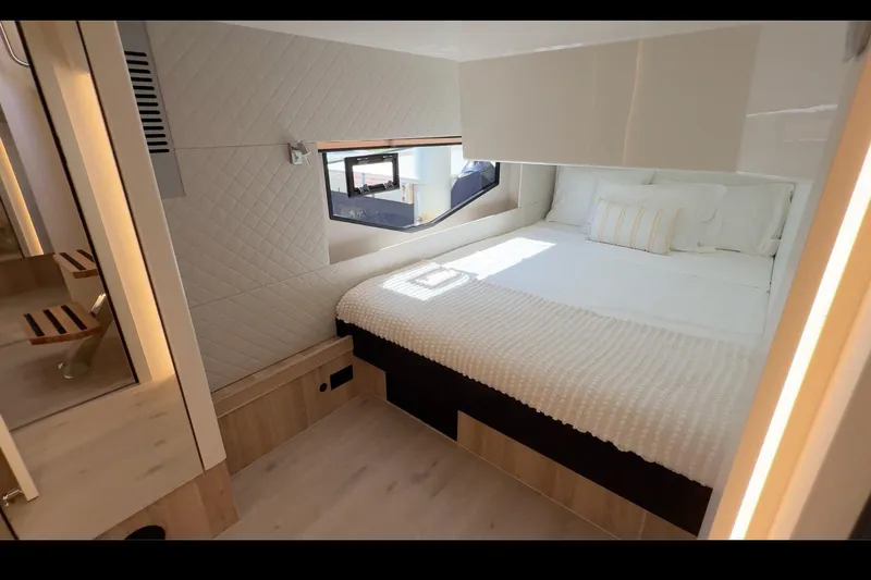  Yacht Photos Pics Luxurious bedroom interior of 2026 Cobra Yachts Seamaster 45, featuring modern design and cozy bedding.