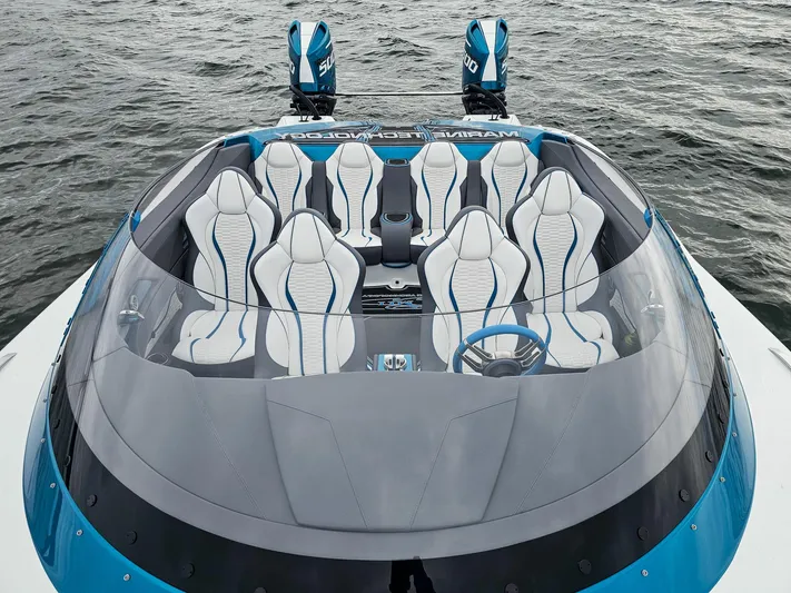  Yacht Photos Pics Luxury MTI 440X 2026 speedboat with sleek design and modern seating on open water.