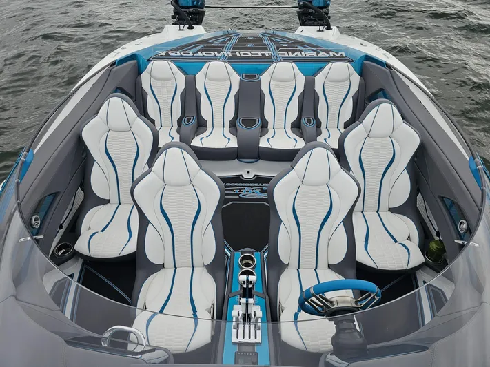  Yacht Photos Pics Luxury MTI 440X 2026 boat interior with sleek white and blue seating on water.