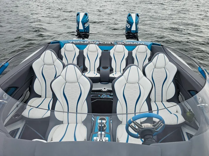  Yacht Photos Pics Luxury MTI 440X 2026 speedboat interior with white and blue seating, dual engines, on water.