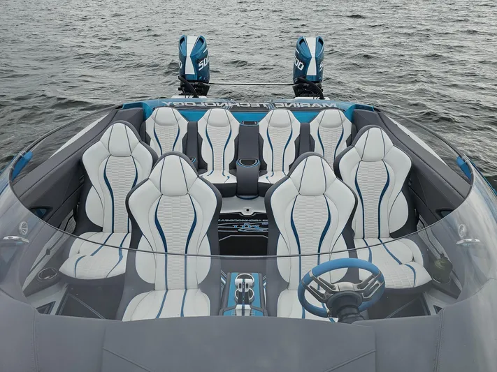  Yacht Photos Pics Luxury MTI 440X 2026 speedboat interior with white and blue seating on water.