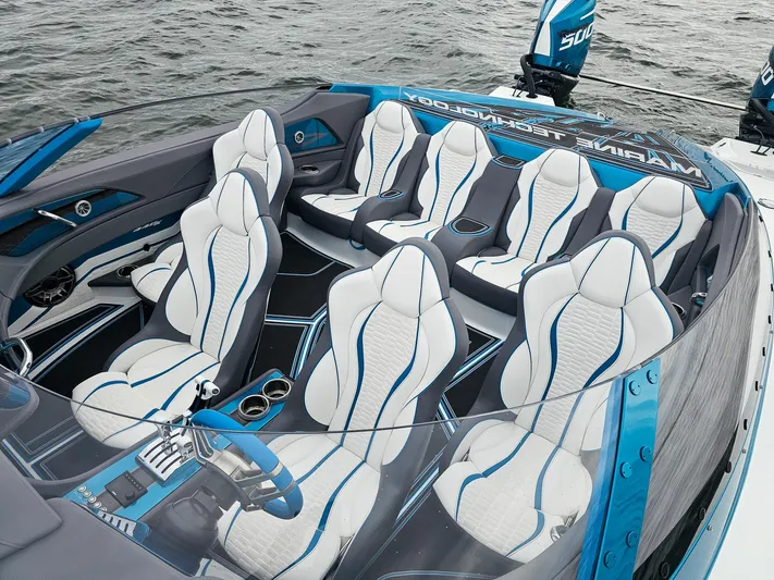  Yacht Photos Pics Luxurious MTI 440X 2026 speedboat interior with sleek white and blue seating design.