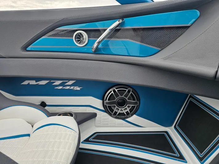  Yacht Photos Pics Interior of 2026 MTI 440X boat with blue accents and speaker system.
