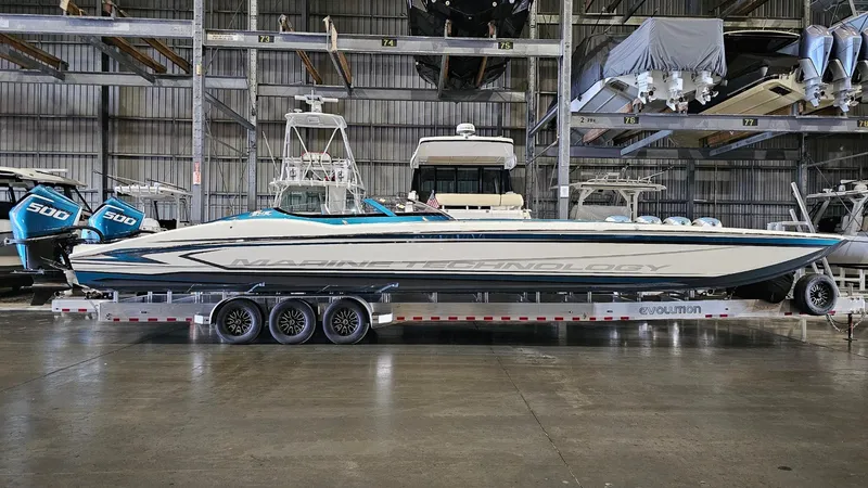  Yacht Photos Pics 2026 MTI 440X powerboat on trailer in indoor storage facility.