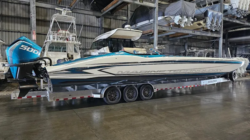  Yacht Photos Pics 2026 MTI 440X powerboat with 500 horsepower engine on trailer in warehouse.