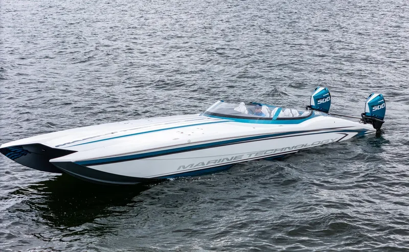  Yacht Photos Pics 2026 MTI 440X speedboat on water, featuring sleek design and dual outboard engines.