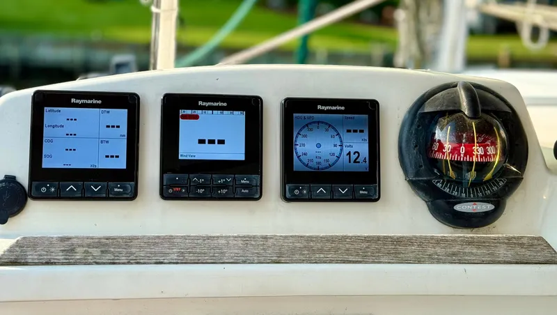 Wander Cat Yacht Photos Pics Control panel of a 2004 Lagoon 380 catamaran with Raymarine displays and compass.