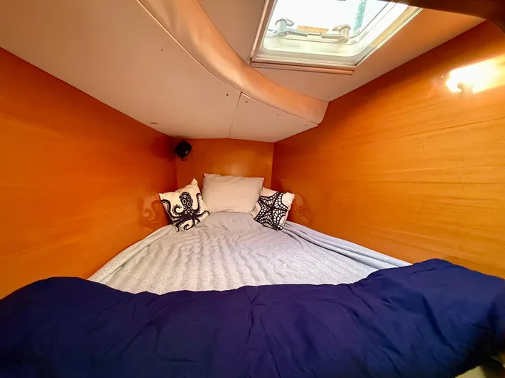 Wander Cat Yacht Photos Pics Cozy cabin interior of 2004 Lagoon 380 catamaran with bed and skylight.