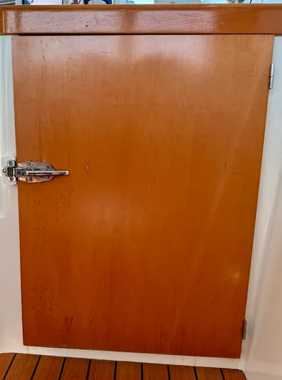 Wander Cat Yacht Photos Pics Wooden door on a 2004 Lagoon 380 catamaran with metal latch.