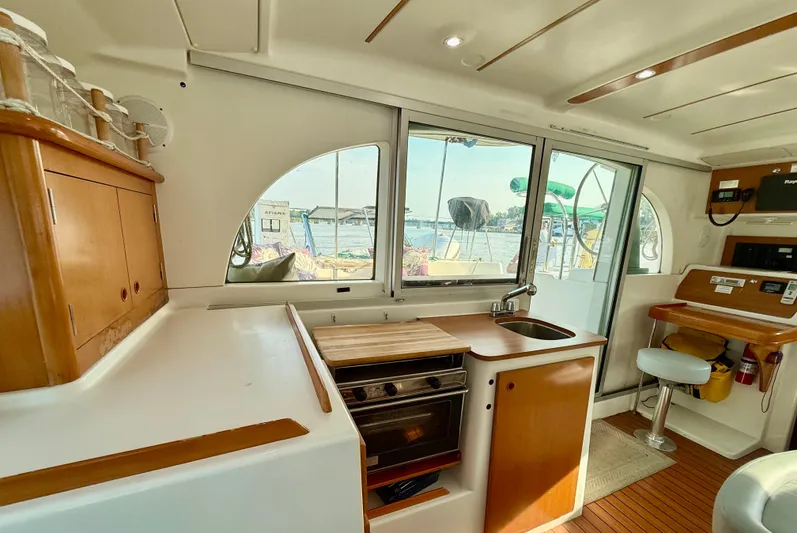 Wander Cat Yacht Photos Pics Interior of a 2004 Lagoon 380 catamaran with kitchen and seating area.