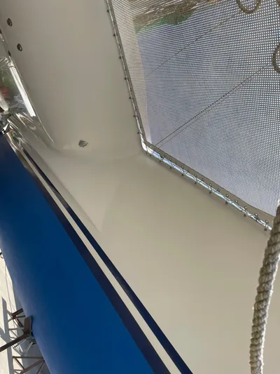 Wander Cat Yacht Photos Pics 2004 Lagoon 380 catamaran deck with blue hull and netting.